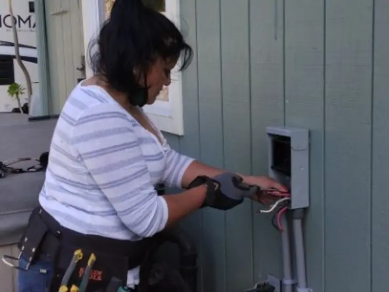 Licensed electrician wiring an exterior subpanel in Mount Rainier